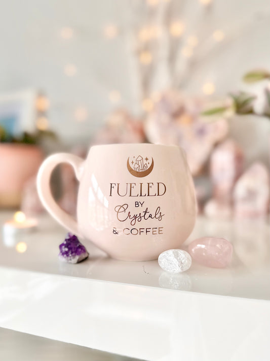 ‘Fueled by crystals and coffee’ light pink Mug